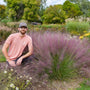Man sitting among muhly grass in a garden setting